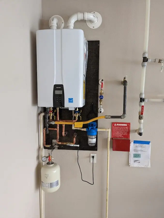 Professional plumber installing copper piping in a Covedale home